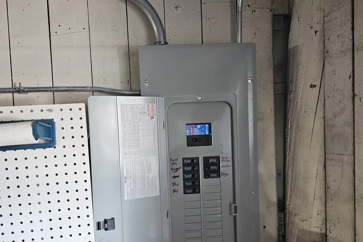 Installed electrical panel with the breaker cover open